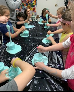 children joyfully playing with brightly colored slime